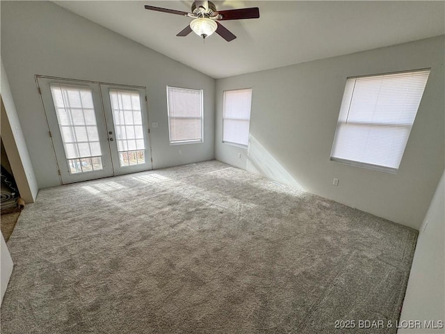 carpeted empty room with french doors, ceiling fan, and vaulted ceiling