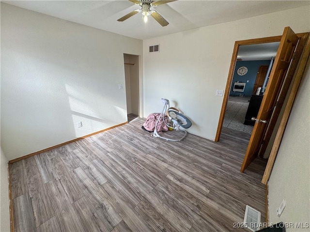 empty room with hardwood / wood-style flooring and ceiling fan