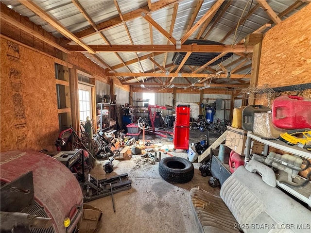 miscellaneous room with lofted ceiling, metal wall, and a garage