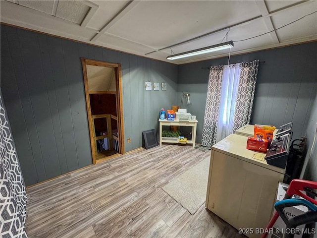 interior space with hardwood / wood-style floors and wooden walls