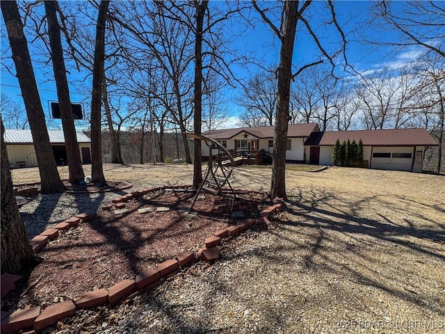 23731 Grant Rd, Barnett, MO 65011 - view of yard with a garage and dirt driveway