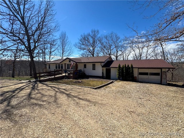 23731 Grant Rd, Barnett, MO 65011 - single story home featuring an attached garage, dirt driveway, and a deck