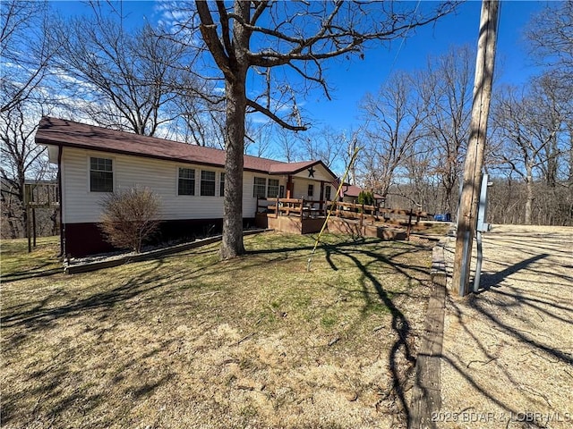 23731 Grant Rd, Barnett, MO 65011 - view of front of house featuring a deck and a front yard