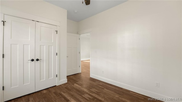 unfurnished bedroom featuring ceiling fan, dark hardwood / wood-style floors, and a closet