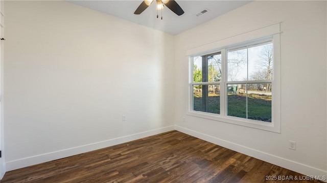 spare room featuring ceiling fan and dark hardwood / wood-style flooring