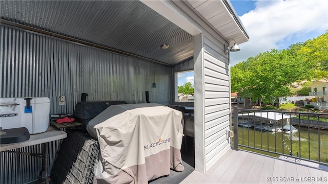 view of patio / terrace featuring a water view and a grill