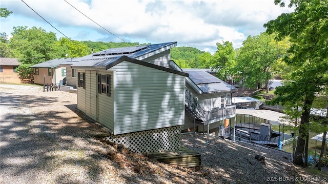 back of property featuring solar panels