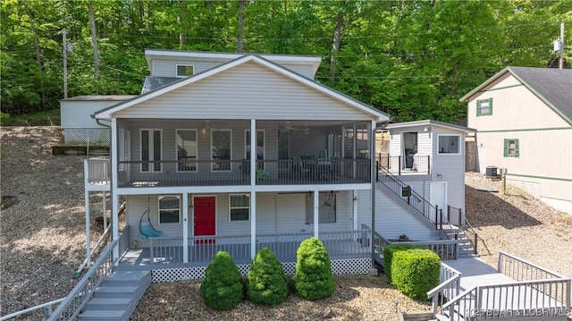 view of front facade with a shed, a porch, and central air condition unit