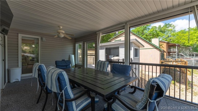 sunroom / solarium featuring a healthy amount of sunlight and ceiling fan