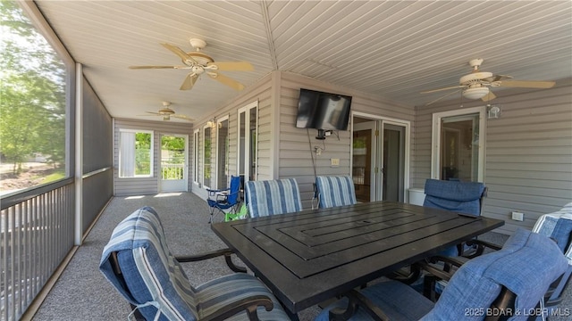 sunroom featuring ceiling fan and wooden ceiling