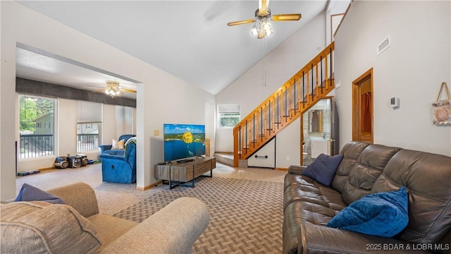 carpeted living room featuring high vaulted ceiling and ceiling fan