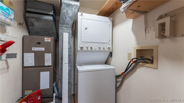 laundry room with stacked washing maching and dryer