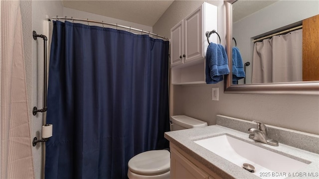 bathroom with toilet and vanity