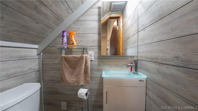 bathroom featuring toilet and vanity