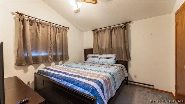 bedroom featuring vaulted ceiling, ceiling fan, and dark colored carpet