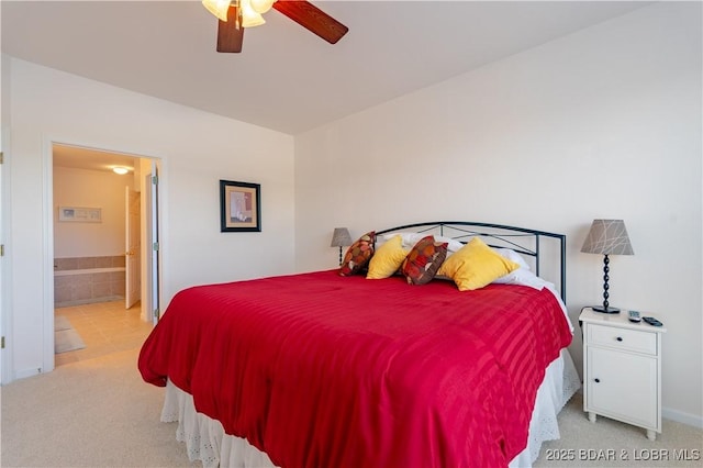 carpeted bedroom with ceiling fan and ensuite bathroom