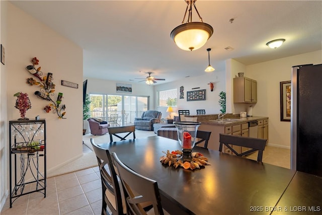 dining area featuring ceiling fan, light tile patterned floors, and sink