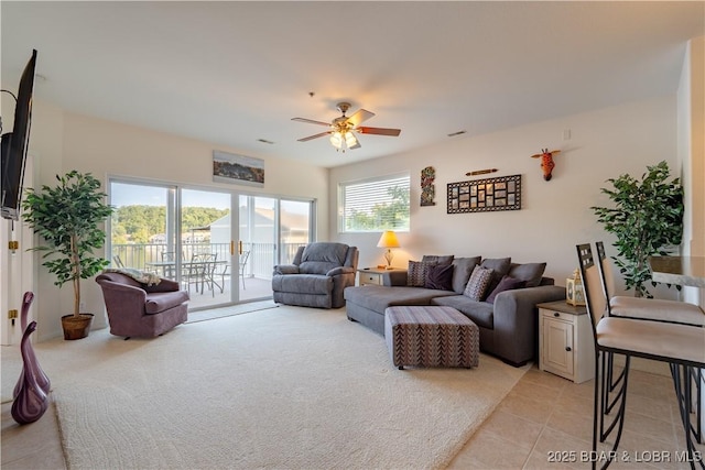 tiled living room with ceiling fan