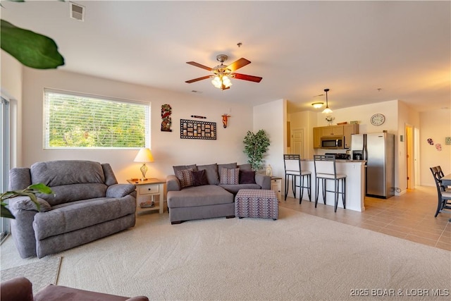 carpeted living room featuring ceiling fan