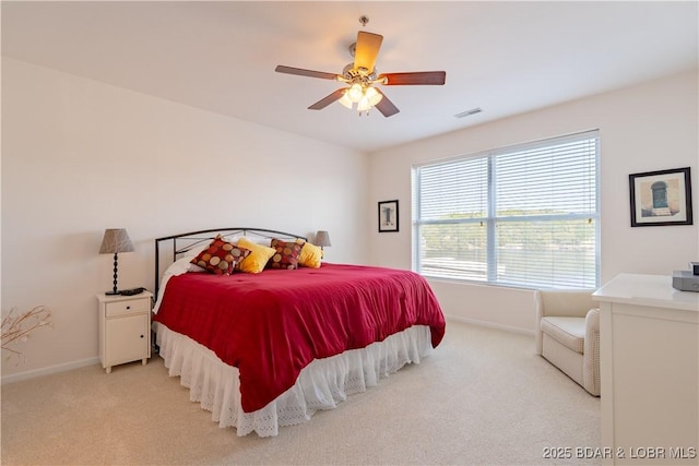 bedroom with ceiling fan and light colored carpet