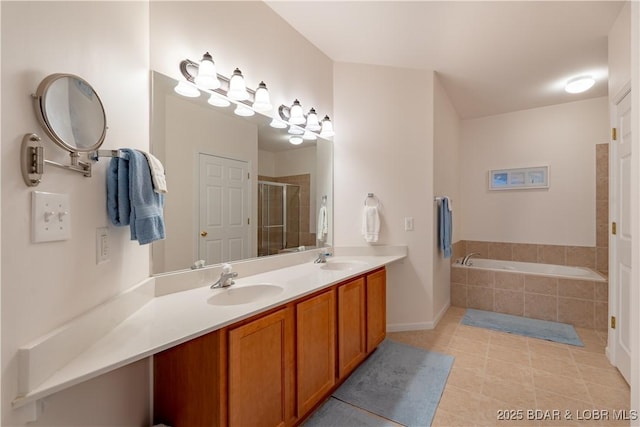 bathroom with plus walk in shower, tile patterned floors, and vanity