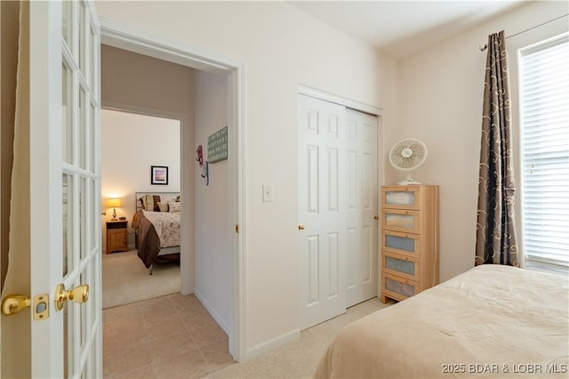 bedroom with a closet and light carpet