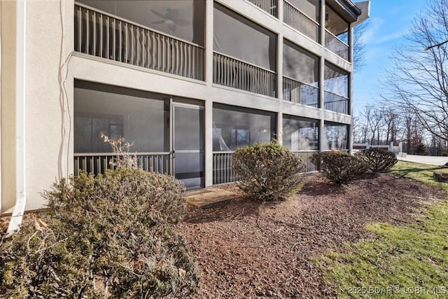 exterior space with ceiling fan