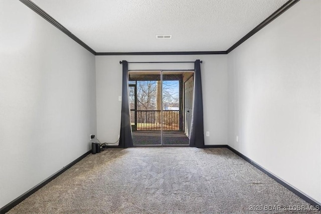 spare room featuring crown molding, carpet, and a textured ceiling