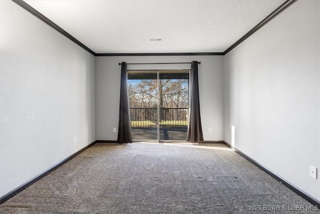 empty room featuring ornamental molding, a textured ceiling, and carpet flooring