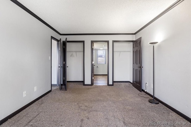 unfurnished bedroom featuring crown molding, carpet, and a textured ceiling