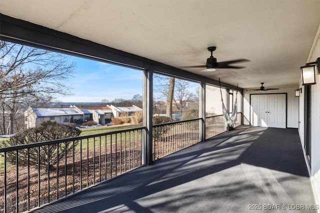 65 Laguna Dr Unit 1A/757, Lake Ozark, MO 65049 - unfurnished sunroom featuring ceiling fan, plenty of natural light, and a residential view