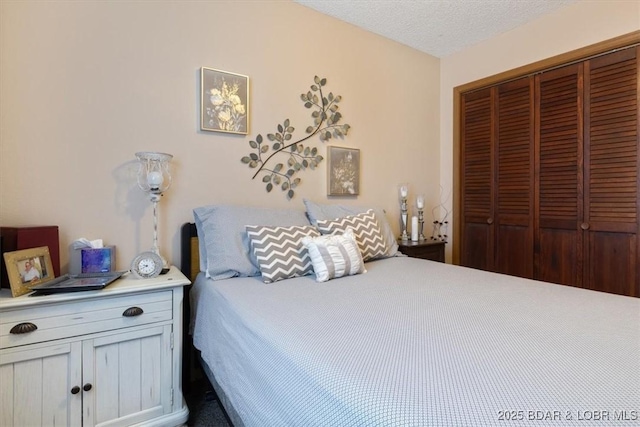 bedroom with a closet and a textured ceiling