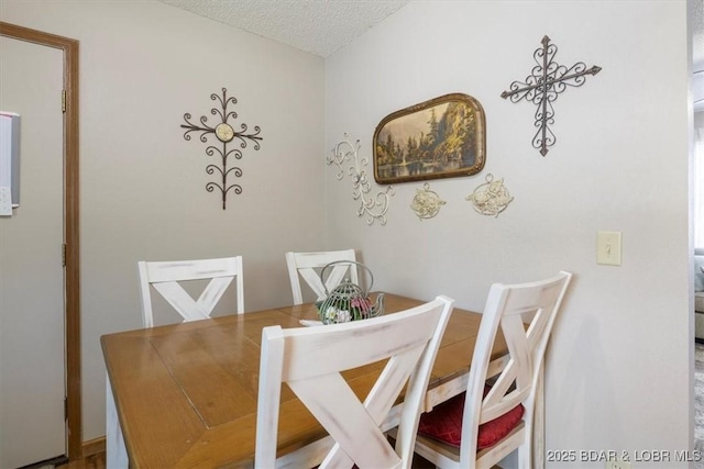 dining area featuring a textured ceiling