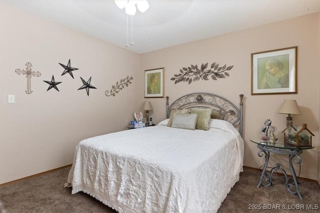 bedroom with ceiling fan and dark colored carpet