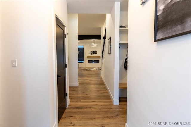 corridor with hardwood / wood-style floors