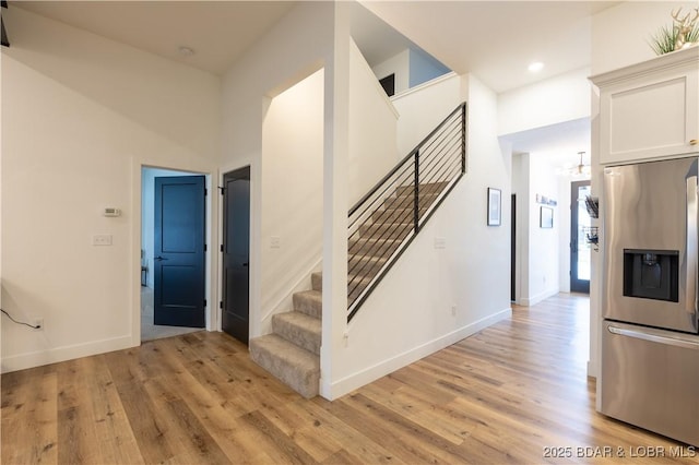 stairway with hardwood / wood-style flooring