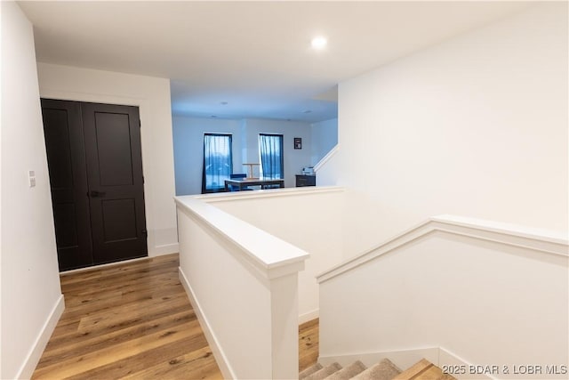 corridor with hardwood / wood-style floors