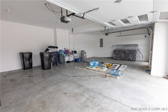 garage with a garage door opener and electric panel