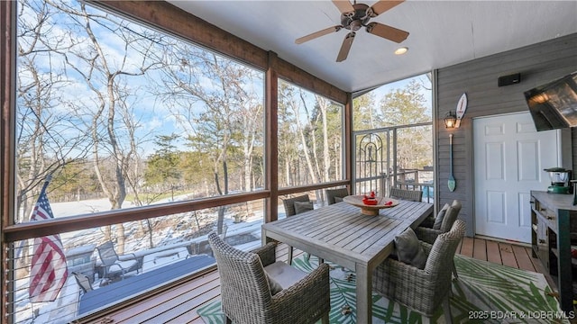sunroom / solarium with ceiling fan and healthy amount of natural light