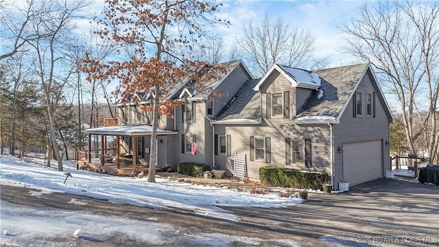 view of front of home with a porch and a garage