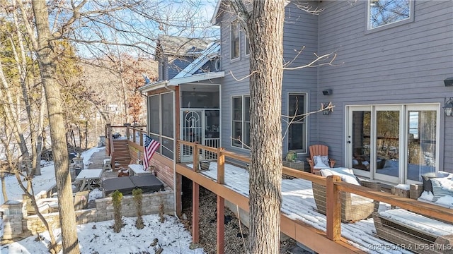 snow covered deck with a sunroom