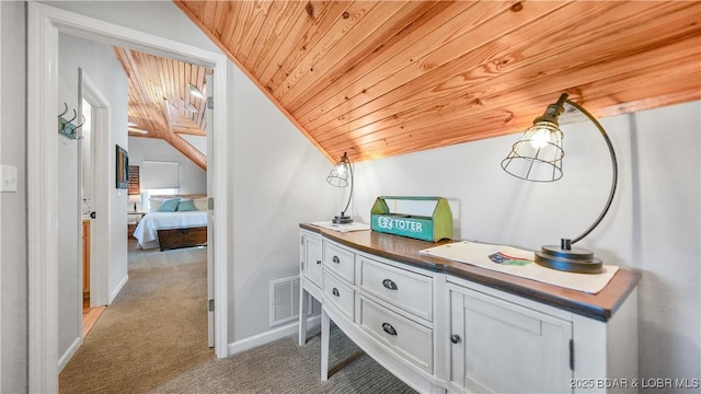 corridor with light colored carpet, vaulted ceiling, wooden ceiling, and baseboards