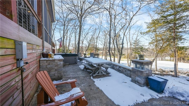 yard covered in snow featuring a hot tub