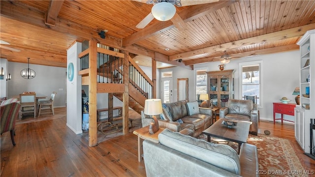 living room with ceiling fan, stairs, wood ceiling, beam ceiling, and baseboards