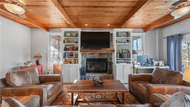 living room featuring a wealth of natural light, wood ceiling, beam ceiling, and a stone fireplace