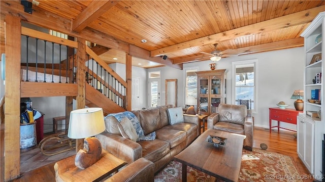 living room with beam ceiling, wood ceiling, a wealth of natural light, and hardwood / wood-style floors