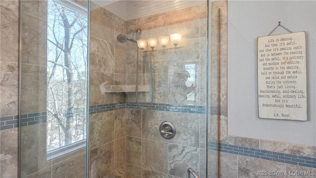 bathroom with tiled shower and plenty of natural light