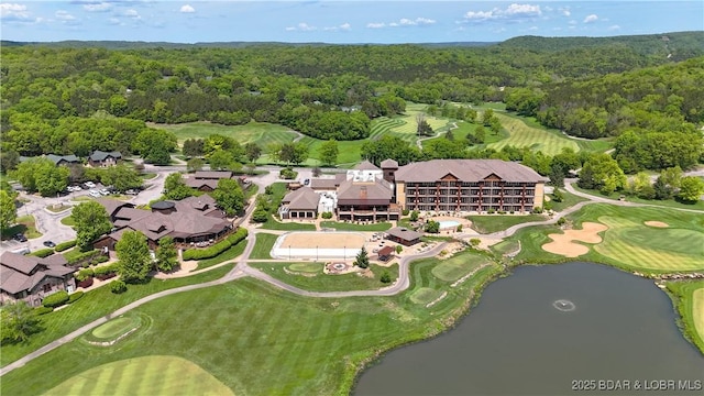 aerial view of a forest, a golf course, and a large body of water