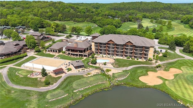 aerial overview of property's location with a forest, a large body of water, and a golf course