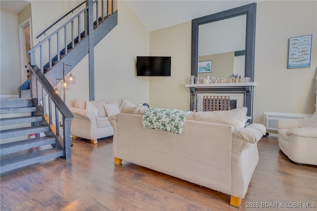 living room featuring indoor bar and hardwood / wood-style flooring